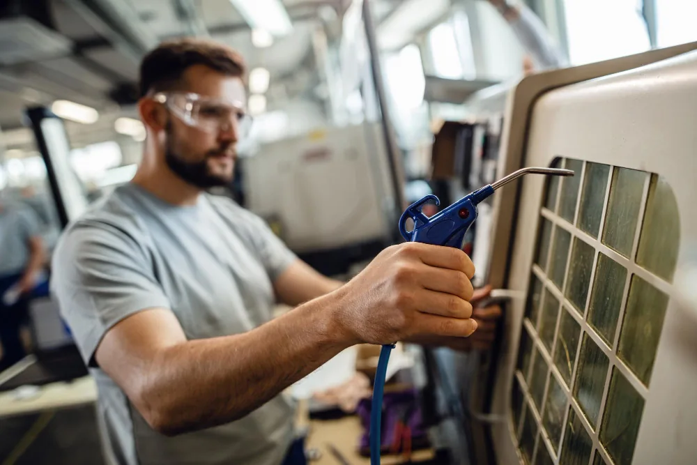 Technician cleaning components on an AC unit